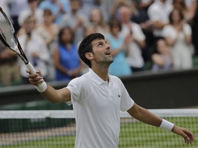 Serbia's Novak Djokovic celebrates defeating Rafael Nadal of Spain during their men's singles semifinals match at the Wimbledon Tennis Championships, in London, Saturday July 14, 2018.