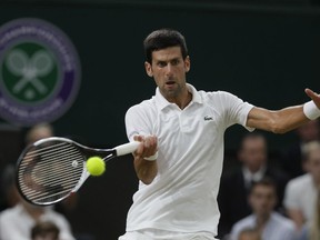 Serbia's Novak Djokovic returns the ball to Rafael Nadal of Spain during their men's singles semifinals match at the Wimbledon Tennis Championships, in London, Friday July 13, 2018.