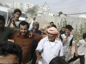 FILE - In this Monday, June 25, 2018 file photo, Yemeni actor Nasser al-Anbari, in brown shirt, is greeted by his family and friends after his release from a prison controlled by the United Arab Emirates where he and others had been held without charges for nearly a year, in Aden, Yemen. In a report released Thursday, July 12, 2018, Amnesty International called for an investigation into alleged disappearances, torture and likely deaths in detention facilities in southern Yemen as possible war crimes. (AP Photo, File)