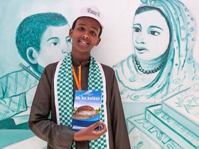 Abdishakur Mohamed,16, a young author from Somaliland, holds up a copy of his book on July 21, 2018, at an  international book fair in Hargeisa, the capital of Somaliland. At the first annual event in 2008, organizers exhibited only a handful of books borrowed from friends and attracted just 200 visitors. Ten years on and literature has taken a prominent place in Somaliland's culture.