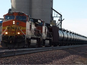 In this Nov. 6, 2013 photo, a BNSF Railway train hauls crude oil west of Wolf Point, Mont.