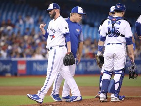 Mike Hauschild of the Blue Jays is taken out of the game by manager John Gibbons in the third inning of their game against the Boston Red Sox at Rogers Centre in Toronto on Wednesday night.