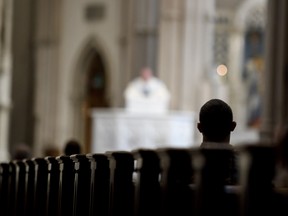 Parishioners worship during a mass to celebrate the Assumption of the Blessed Virgin Mary at St Paul Cathedral, the mother church of the Pittsburgh Diocese on August 15, 2018 in Pittsburgh, Pennsylvania.