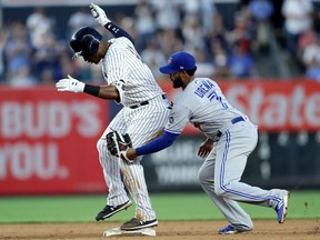 Miguel Andujar of the New York Yankees makes it safely to second as Richard Urena of the Toronto Blue Jays tries to make the tag during the first inning on Friday night at Yankee Stadium in New York.