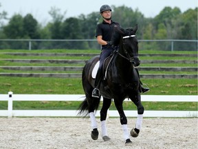Horse trainer Daniel Kehres rides Judicial, a six-year-old Hanoverian mare that is up for auction at the RCMP stables in Ottawa.