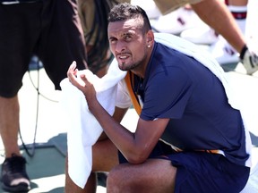 Nick Kyrgios takes a break during his second-round match against Pierre-Hugues Herbert at the U.S. Open on Aug. 30.