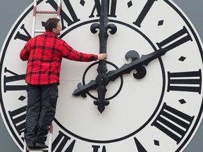 Picture taken on March 23, 2018 shows a technician working on the clock of the Lukaskirche Church in Dresden, eastern Germany.