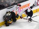 In this May 30 file photo, Washington Capitals defenseman John Carlson (right) checks Vegas Golden Knights forward James Neal into the boards during Game 2 of the Stanley Cup Finals.