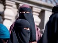 In this file photo taken on May 31, 2018 women wearing the niqab leave the Danish Parliament in Copenhagen, Denmark.