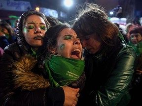 Activists in favour of the legalization of abortion comfort each other outside the National Congress in Buenos Aires, on August 9, 2018 after senators rejected the bill to legalize the abortion.