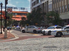 This handout image distributed courtesy of WJXT, a local Jacksonville television station, shows police cars blocking a street leading to the Jacksonville Landing area in downtown Jacksonville, Florida, August 26, 2018.