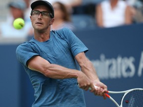 Peter Polansky of Canada hits a return to Alexander Zverev of Germany during their first-round men's match at the U.S. Open in New York.
