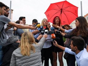 Concha Borrell (C), secretary general of the Organisation of Sex Workers union (OTRAS), and Sabrina Sanchez (C-R), secretary general of Aprosex association, hold a press conference in Barcelona on August 31, 2018 after the Spanish government announced it had launched proceedings to challenge in court the existence of OTRAS, which promises to defend the rights of people in the industry.