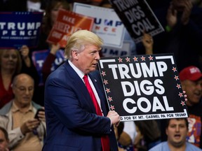 Republican presidential nominee Donald Trump  holds a sign supporting coal during a rally at Mohegan Sun Arena in Wilkes-Barre, Pennsylvania on October 10, 2016.