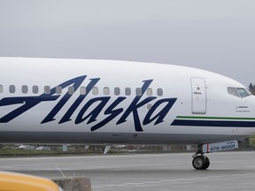 An Alaska Airlines plane taxis Friday, April 13, 2018, at the Seattle-Tacoma International Airport in Seattle.