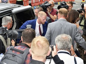 England cricketer Ben Stokes centre,  arrives at Bristol Crown Court for his court case, in Bristol, England, Monday Aug. 6, 2018. The all-rounder and two other men, Ryan Ali and Ryan Hale are jointly charged with affray in the Clifton Triangle area of Bristol on Sept. 25 last year – several hours after England had played a one-day international against the West Indies in the city.