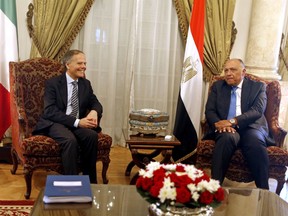 Italian Foreign Minister Enzo Moavero Milanesi, left, meets with his Egyptian counterpart, Sameh Shoukry, at Tahrir Palace, in Cairo, Egypt, Sunday, Aug. 5, 2018.