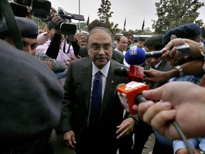 Pakistan's newly elected lawmaker and former president of Pakistan, Asif Ali Zardari, center, arrives to attend the first session of the lower house of parliament in Islamabad, Pakistan, Monday, Aug. 13, 2018. Pakistan's newly elected parliament met in Islamabad on Monday for the first time since last month's general elections, which saw the party of former cricket star-turned-politician Imran Khan's party winning most seats as compared to his political rivals and he is expected to be elected the new premier later this week.