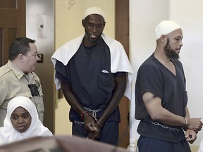 Defendants, from left, Jany Leveille, Lucas Morton and Siraj Wahhaj enter district court in Taos, N.M., for a detention hearing, Monday, Aug. 13, 2018.