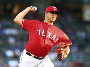 Texas Rangers starting pitcher Ariel Jurado (57) delivers a pitch against the Los Angeles Dodgers in the first inning of a baseball game Tuesday, Aug. 28, 2018, in Arlington, Texas.