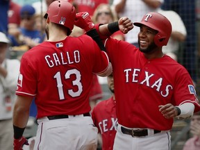 Texas Rangers Joey Gallo (13) is congratulated by Elvis Andrus after he hit a home run against the Seattle Mariners during the third inning of a baseball game Wednesday, Aug. 8, 2018, in Arlington, Texas.