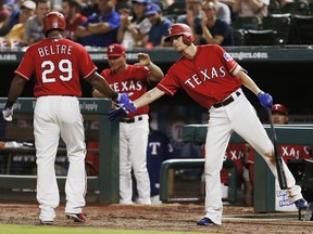 Texas Rangers' Adrian Beltre (29) is congratulated by Carlos Tocci, right, after scoring on an RBI single hit by Robinson Chirinos, not pictured, during the eighth inning of a baseball game against the Arizona Diamondbacks, Monday, Aug. 13, 2018, in Arlington, Texas. Texas won 5-3.