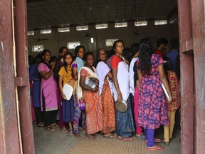 Women line up for food being distributed at a relief camp set up for flood effected people at a Christian missionary run school in Alappuzha in the southern state of Kerala, India, Monday, Aug. 20, 2018. Kerala has been battered by torrential downpours since Aug. 8, with floods and landslides killing at least 250 people. About 800,000 people now living in some 4,000 relief camps.