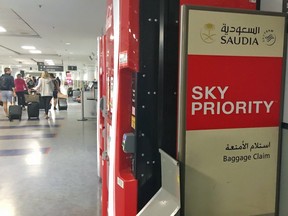 A passenger information sign for Saudia Saudi Arabian Airlines sits tucked away behind a vending machine in the international baggage hall at Lester B. Pearson International Airport in Toronto, Ont. on Sunday, Aug. 12 2018.