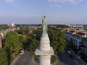 FILE - This Aug. 22, 2017, file photo shows part of the Confederate President Jefferson Davis on Monument Avenue in Richmond, Va. Virginia has one of the oldest state laws protecting war monuments. Richmond's city attorney warned that removing any of the statues would risk fines and possible criminal charges.