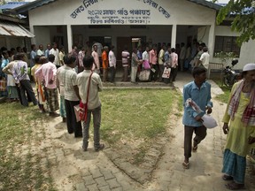 People whose names were left out in the National Register of Citizens (NRC) draft stand in a queue to collect forms to file appeals in Mayong, 45 kilometers (28 miles) east of Gauhati, India, Friday, Aug. 10, 2018. A draft list of citizens in Assam, released in July, put nearly 4 million people on edge to prove their Indian nationality. Nativist anger churns through Assam, just across the border from Bangladesh, with many believing the state is overrun with illegal migrants.
