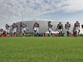 The Arizona Cardinals run during an NFL football practice, Tuesday, July 31, 2018, in Glendale, Ariz.