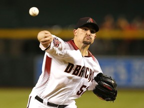 Arizona Diamondbacks pitcher Zack Godley throws in the first inning during a baseball game against the Philadelphia Phillies, Monday, Aug. 6, 2018, in Phoenix.