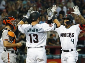 Arizona Diamondbacks Ketel Marte (4) celebrates with Nick Ahmed after hitting a two-run home run against the San Francisco Giants in the first inning during a baseball game, Saturday, Aug. 4, 2018, in Phoenix.