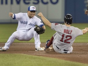 Boston Red Sox' Brock Holt is out trying to steal second as the Blue Jays' Aledmys Diaz stretches to apply the tag during the fifth inning of their game Thursday night at Rogers Centre in Toronto.