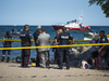 Emergency personnel and lifeguards search Lake Ontario just off the shore at Toronto’s Woodbine Beach to ensure a group of swimmers who were distress were all accounted for, August 10, 2018.