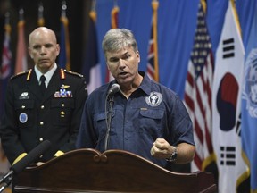 John Byrd, director of scientific analysis at the Defense POW/MIA Accounting Agency (DPAA), center, speaks as U.S. Lieutenant General Wayne Eyre, deputy commander of the United Nations Command, looks on before a repatriation ceremony for the remains of U.S. soldiers killed in the Korean War and collected in North Korea, at the Osan Air Base in Pyeongtaek, South Korea, Wednesday, Aug. 1, 2018. North Korea handed over 55 boxes of the remains last week as part of agreements reached during a historic June summit between its leader Kim Jong Un and U.S. President Donald Trump.