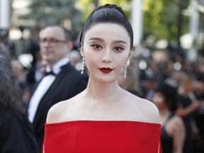 FILE - In this May 24, 2017, file photo, Fan Bingbing poses for photographers as she arrives for the screening of the film The Beguiled at the 70th international film festival, Cannes, southern France. Chinese actress Fan has disappeared from social media amid rumors she is the target of a tax evasion investigation and that she, her brother and boyfriend have been barred from leaving China.