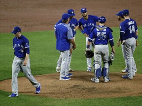 Toronto Blue Jays starting pitcher Ryan Borucki, left, walks off the field after being relieved in the fifth inning of their game against the Orioles on Wednesday night in Baltimore. Borucki gave up a grand slam to the Orioles in the inning.