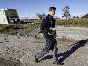 In this Dec. 1, 2008, file photo, Brad Pitt walks in the Lower 9th Ward between a home built by the Make It Right Foundation and a FEMA trailer in New Orleans.