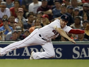 Boston Red Sox's Brock Holt can't get to a single by Cleveland Indians' Yan Gomes during the fourth inning of a baseball game Wednesday, Aug. 22, 2018, in Boston.