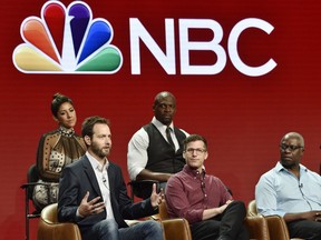 Dan Goor, bottom left, executive producer of the NBC Universal television series "Brooklyn Nine-Nine," answers a question as cast members, from left, Stephanie Beatriz, Terry Crews, Andy Samberg and Andre Braugher look on during the 2018 Television Critics Association Summer Press Tour, Wednesday, Aug. 8, 2018, in Beverly Hills, Calif. The series was picked up by NBC Universal after being cancelled this year by FOX.