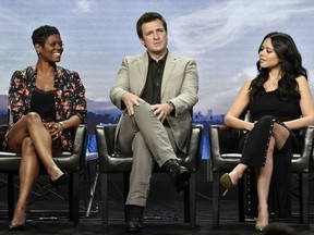 From left, Afton Williamson, Nathan Fillion and Alyssa Diaz, cast members in the Disney ABC television series "The Rookie," take part in a Q&A session during the 2018 Television Critics Association Summer Press Tour, Tuesday, Aug. 7, 2018, in Beverly Hills, Calif.