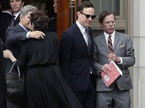 FILE - In this Thursday, June 21, 2018 file photo, Andy Spade, right, leaves his wife's service at Our Lady of Perpetual Help Catholic Church in Kansas City, Mo. Spade, the widower of Kate Spade, returned to Instagram late Monday, July 30, 2018, with a heartfelt dedication to the late fashion designer nearly two months after her death.
