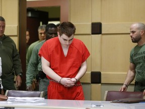 FILE - In this Friday, Aug. 3, 2018 file photo, school shooting suspect Nikolas Cruz arrives at a Broward County courtroom for a hearing in Fort Lauderdale, Fla. A newly released transcript shows Florida school shooting suspect Cruz spat out "kill me" and then cursed as he sat alone in a sheriff's interrogation room just hours after the massacre that left 17 dead. Prosecutors released a redacted transcript of Cruz's post-shooting statement Monday afternoon, Aug. 6.