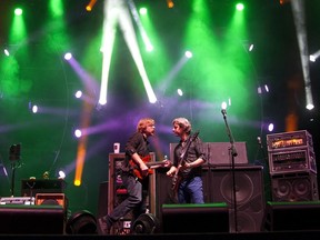 FILE - In this June 10, 2012 file photo, Phish performs during the Bonnaroo Music and Arts Festival in Manchester, Tenn. A three-day Phish festival was washed out by dirty water from torrential rains in central New York just as the band was about to go onstage for its traditional sound check jam Thursday afternoon, Aug. 16, 2018. The Curveball festival was expected to draw more than 30,000 fans to the Finger Lakes village of Watkins Glen starting on Friday.