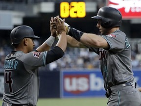 Arizona Diamondbacks' Paul Goldschmidt, right, is greeted by Eduardo Escobar after hitting a two-run home run during the first inning of a baseball game against the San Diego Padres on Friday, Aug. 17, 2018, in San Diego.