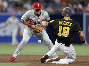 Philadelphia Phillies second baseman Asdrubal Cabrera, left, drops the ball as San Diego Padres' Austin Hedges (18) safely steals second during the second inning of a baseball game Friday, Aug. 10, 2018, in San Diego.