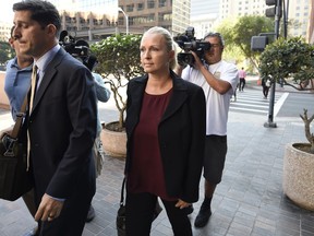 Margaret Hunter, center, the wife of U.S. Rep. Duncan Hunter, arrives for an arraignment hearing Thursday, Aug. 23, 2018, in San Diego. Hunter and his wife were indicted this week on federal charges that they used more than $250,000 in campaign funds for personal expenses that ranged from groceries to golf trips and lied about it in federal filings, prosecutors said.