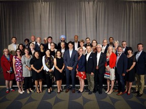 Prime Minister Justin Trudeau and his cabinet (front row from left to right), Carolyn Bennett, Filomena Tassi, Melanie Joly, Mary Ng, Maryam Monsef, Chrystia Freeland, Karina Gould, Seamus O' Reagan, Jim Carr, Catherine McKenna, Pablo Rodriguez, Ginette C. Petitpas Taylor, Scott Brison, (middle row, from left to right,), Jody Wilson-Raybould, Carla Qualtrough, Bardish Chagger, Diane Lebouthillier, Francois-Philippe Champagne, Marie-Claude Bibeau, Jane Philpott, Lawrence MacAulay, Patty Hajdu, Ralph Goodale, (back left to right), Bill Morneau, Harjit Singh Sajjan, Bill Blair, Jean-Yves Duclos, Marc Garneau, Dominic Leblanc, Navdeep Singh Bains, Ahmed D. Hussen, Jonathan Wilkinson and Amarjeet Sohi pose for a family photo at the Vancouver Island Conference Centre during the Liberal cabinet retreat in Nanaimo, B.C., on Tuesday, August 21, 2018.