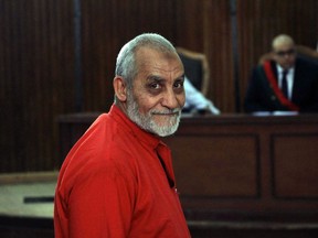 FILE - In this April 20, 2015 file photo, Muslim Brotherhood Supreme Guide Mohammed Badie wears a red jumpsuit that designates he has been sentenced to death, during a court hearing in Tora prison, Cairo, Egypt. An Egyptian court sentenced five people, including Badie, to life in prison on violence-related charges, Sunday, Aug. 12, 2018. It's the latest of several life sentences for Mohammed Badie, who has also been sentenced to death in separate trials since his 2013 arrest.